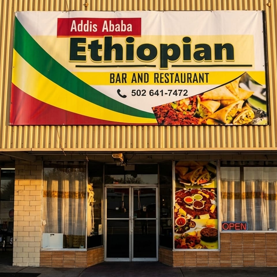 Addis Ababa Ethiopian Bar and Restaurant storefront with a large sign and food images in windows.